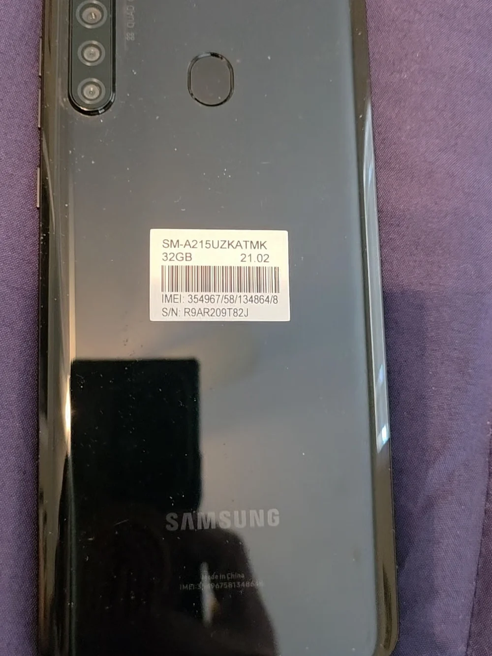 Samsung Smartphone with Black Case on Purple Surface